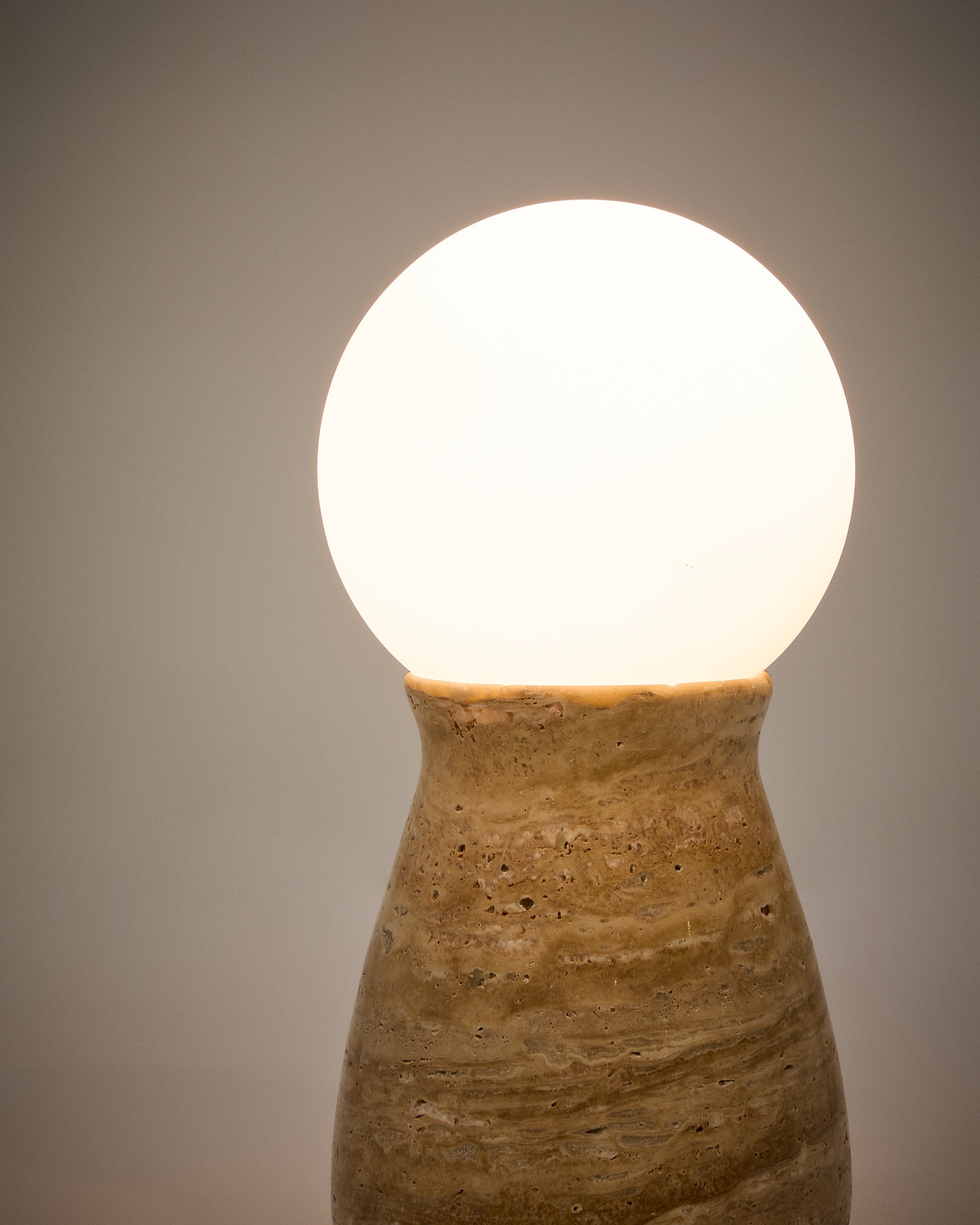 Okeni table lamp made of travertine and glass