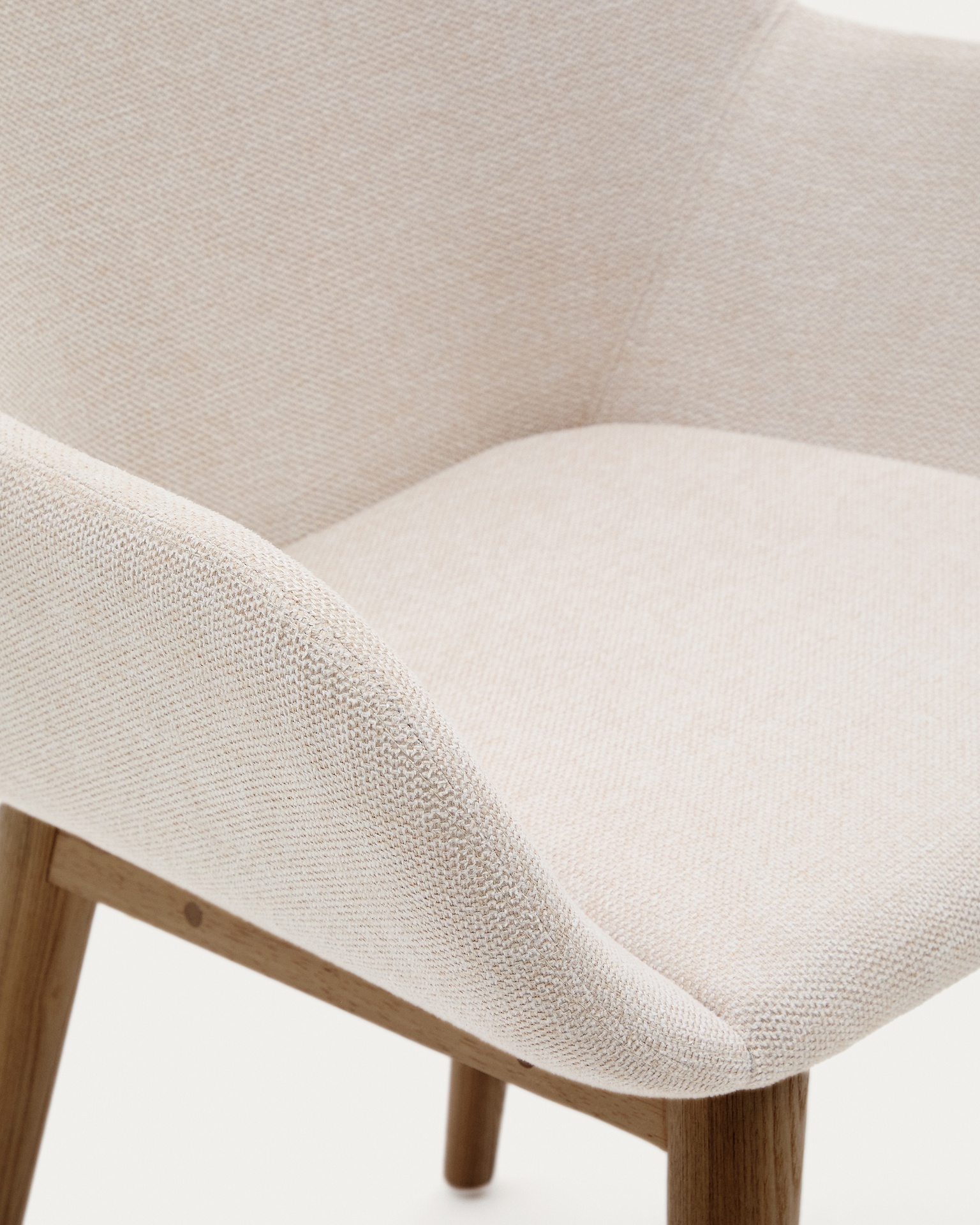 Konna chair in beige with solid ash wood legs in a dark finish
