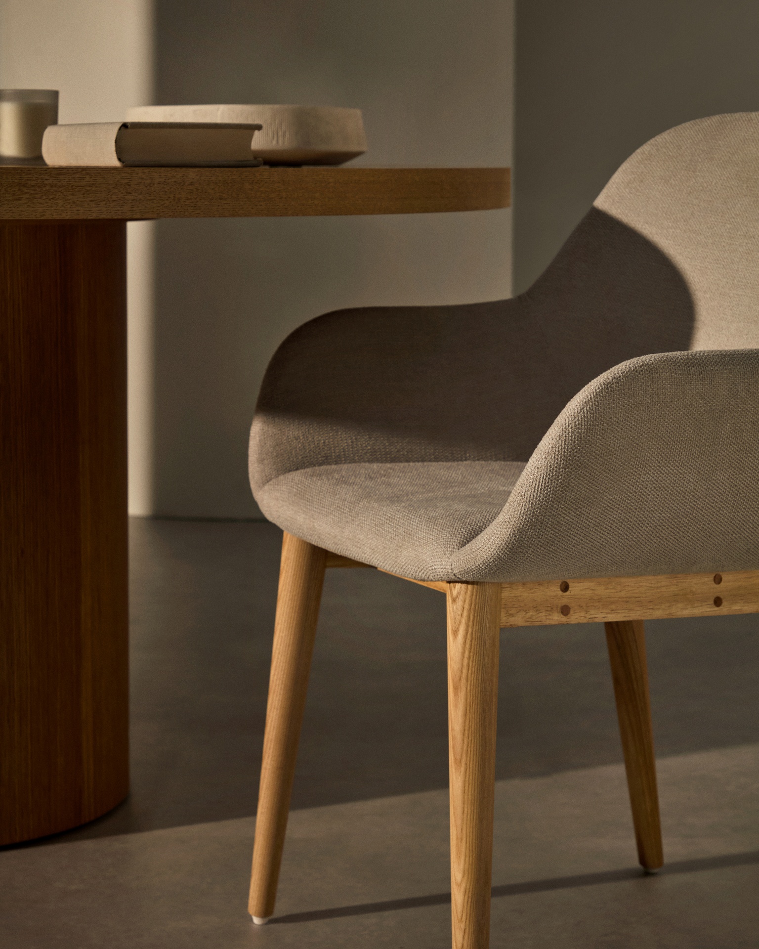 Konna chair in beige with solid ash wood legs in a natural finish